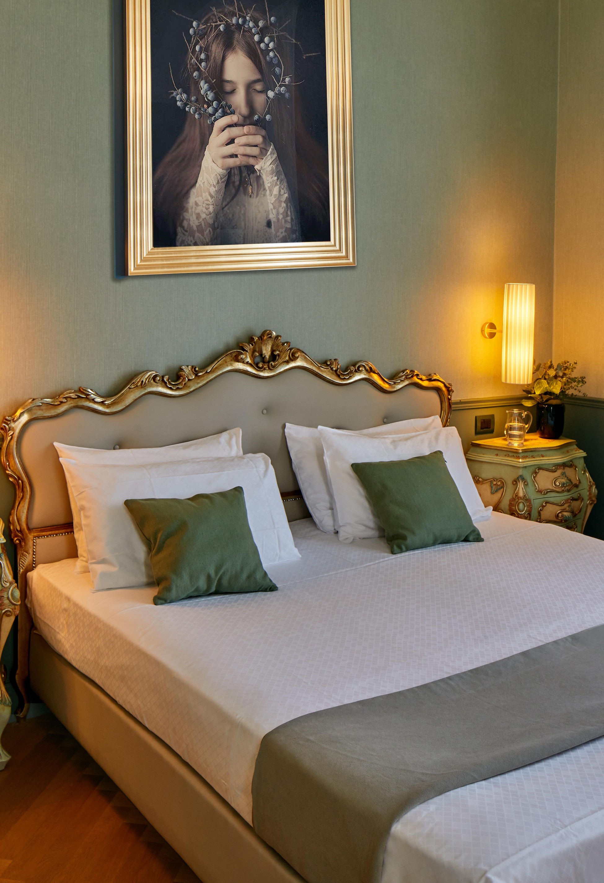 Elegant bedroom with ornate headboard and green pillows